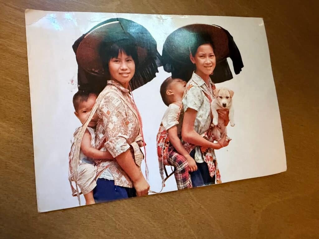 The front of the 1980 Hong Kong postcard from Memaw, showing two women in traditional wide-brimmed hats carrying children
