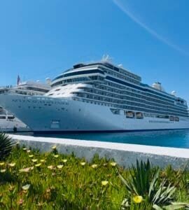 The Regent Seven Seas Splendor luxury cruise ship docked in port under a clear blue sky