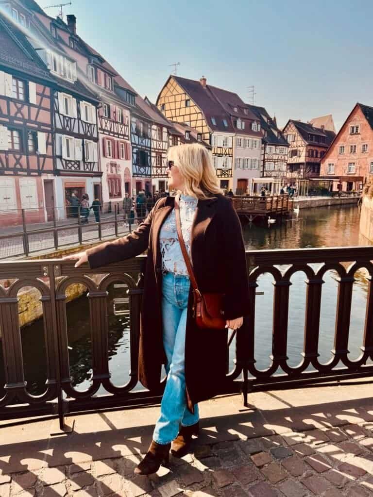 Travel advisor Charity on a colorful European street with half-timbered buildings