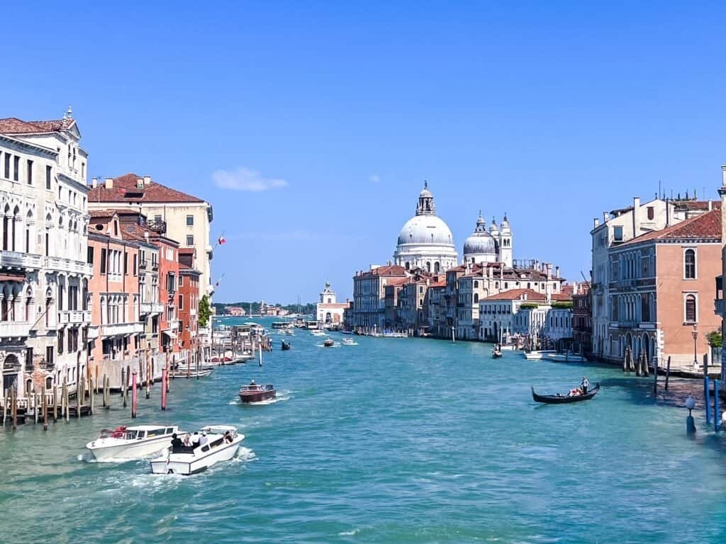 The Grand Canal in Venice lined with palazzos, with the domed Santa Maria della Salute basilica in the distance, Italy