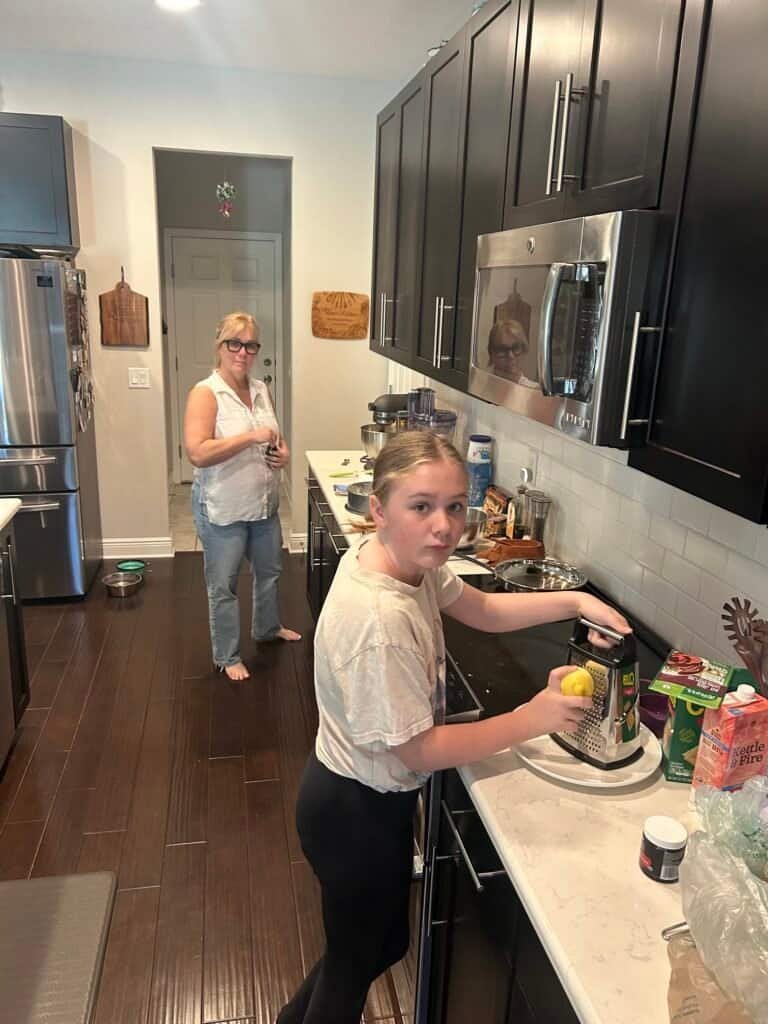 Charity and her granddaughter Charlie making Christmas cookies for Santa in the kitchen