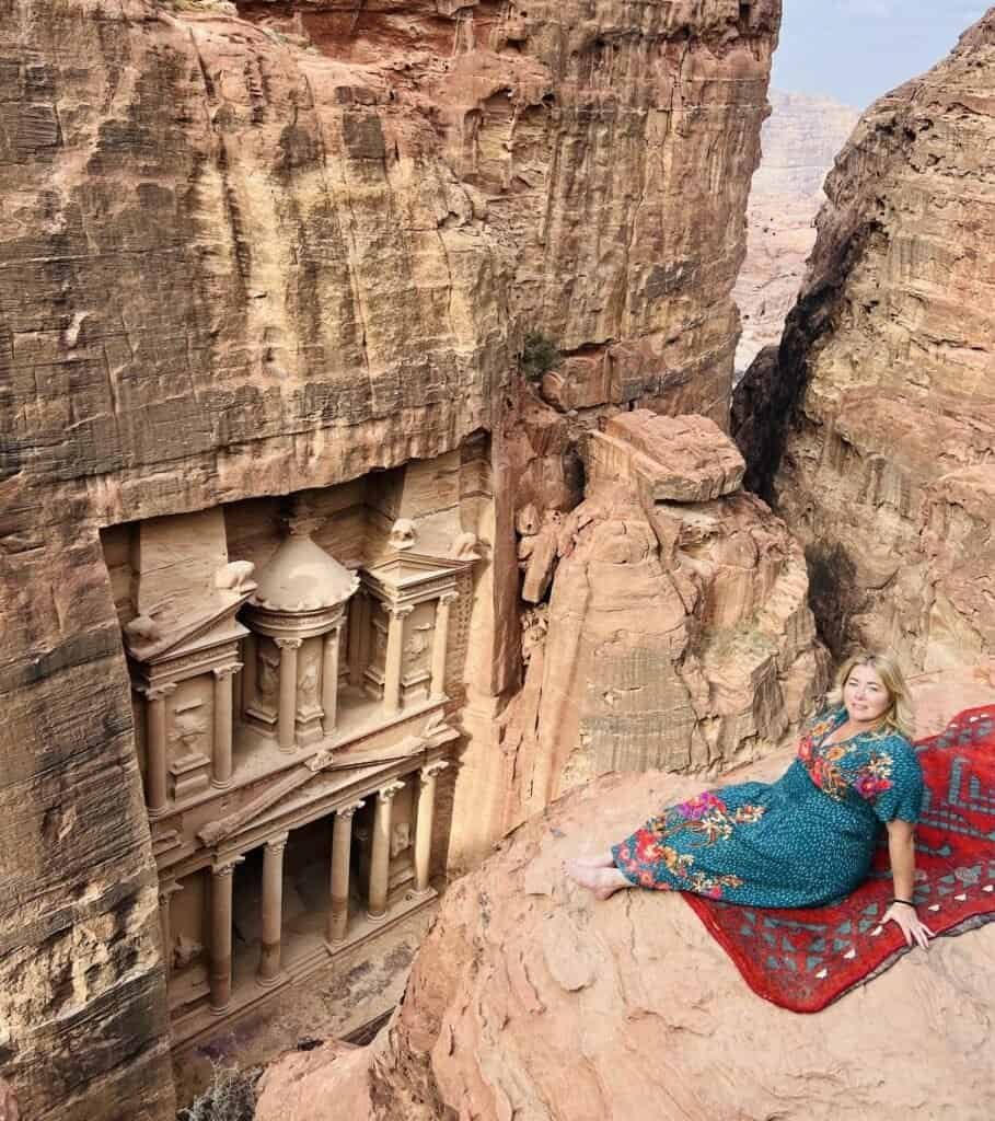 Charity resting on a rug above the Treasury at Petra, Jordan, carved into the rose-red cliffs