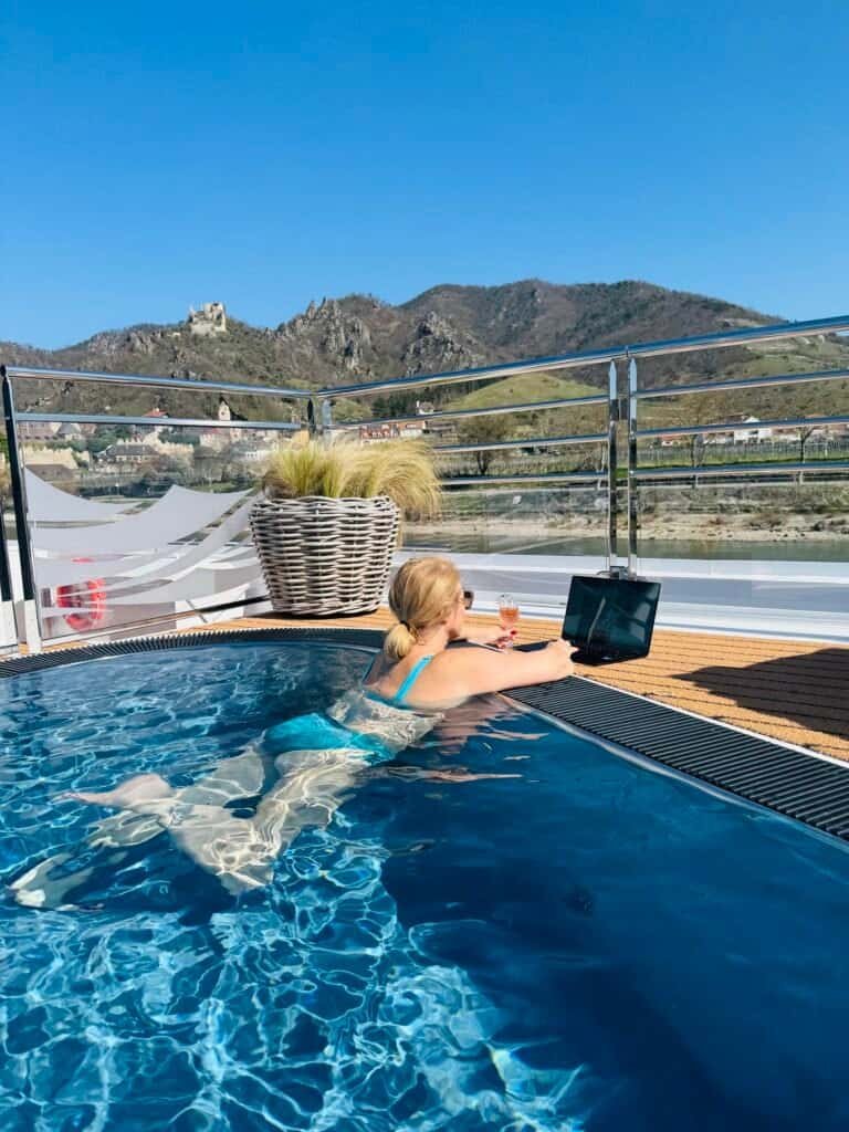 Deck pool with wine and laptop