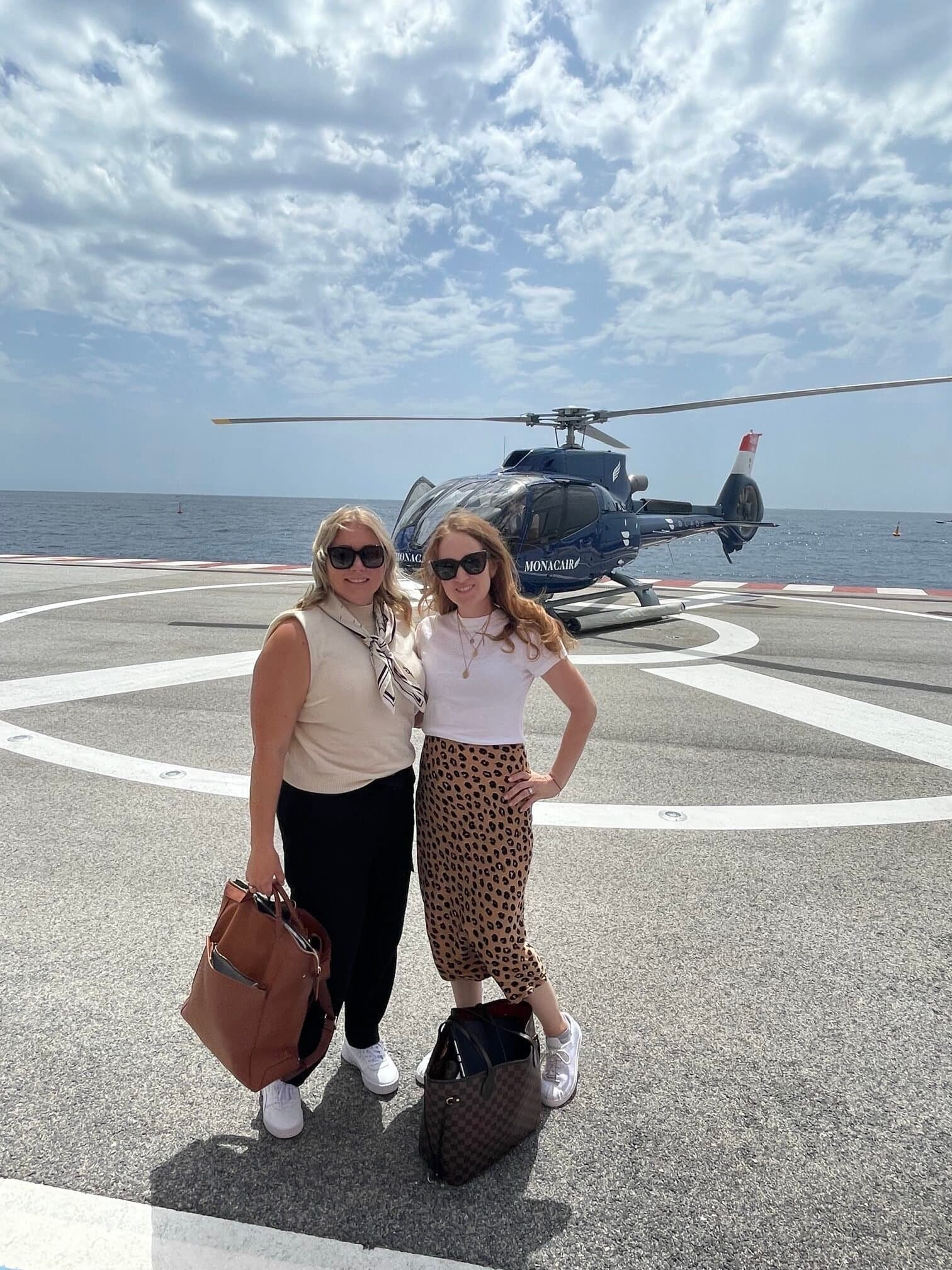 Charity and her sister on the Monacair helipad with the Mediterranean behind them